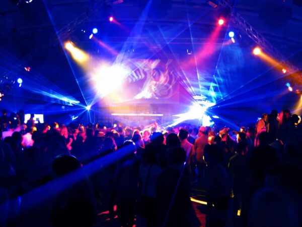 A crowd of people in a room with lights.