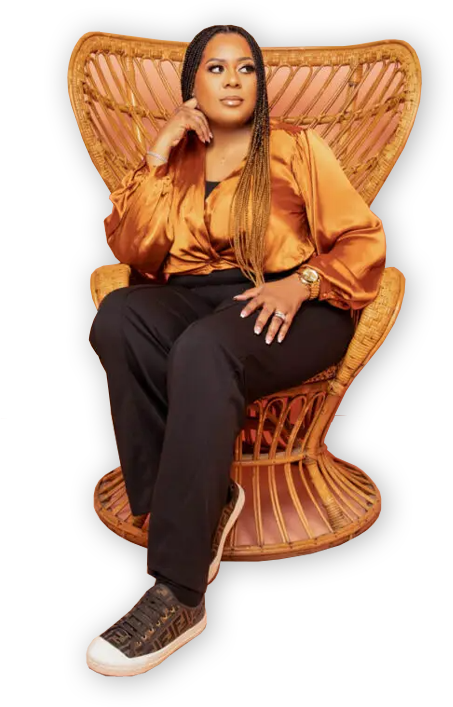 A woman sitting in an orange chair with her hand on her chin.